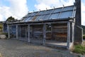 Old, dilapidated log cabin with a weathered shingled roof