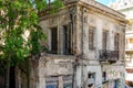 Old Dilapidated Neoclassical Two Floor House in Patras Downtown, Greece. Abandoned Residence with Big Windows, Yard and a Balcony