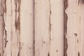 Old dilapidated wall of planks with peeling paint