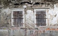 Old dilapidated wall with two shuttered windows Royalty Free Stock Photo