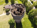 old dilapidated water tower aerial photo in the daytime summer