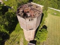 old dilapidated water tower aerial photo in the daytime summer