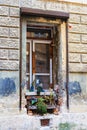 The old dilapidated window with vases of flowers Royalty Free Stock Photo