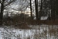 An old dilapidated wooden house in a winter landscape. An abandoned village Royalty Free Stock Photo