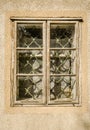 An old dilapidated wooden window frame in the wall of the house Royalty Free Stock Photo