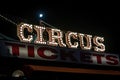 Old dimly lit circus sign with light bulbs in the dark over a ticket stand. Typical view of an entrance to a circus. Concept of Royalty Free Stock Photo