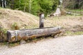 Worn out drinking fountain along a gravel path in the mountains Royalty Free Stock Photo