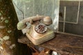 Old dirt broken abandoned disk telephone - no communication offline rusty