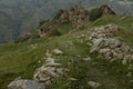 Old dirt road with stones to ancient ruin of stone impregnable city on peak of mountain in highlands in Dagestan in blur.