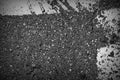 Old dirty asphalt surface with white paint on it. Top view black and white Royalty Free Stock Photo