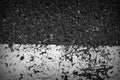 Old dirty asphalt surface with white paint on it. Top view black and white Royalty Free Stock Photo