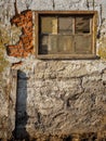 Old dirty barn window and damaged wall