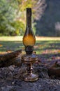 Old dirty blackened kerosene lamp on rock.