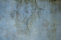 A old dirty blue-green wall with a large crack and stains of dirt, mold and moss. rough texture. rough concrete wall Royalty Free Stock Photo