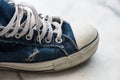 Old dirty blue sneaker. Teenager fashion