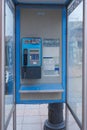 Old and dirty blue telephone cabin