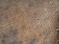 Old dirty burlap close-up. Textured burlap background. The texture of dirty old burlap. The structure of the braided thread web Royalty Free Stock Photo