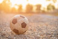 Old and dirty classic soccer ball at the countryside in the morning Royalty Free Stock Photo