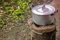 Old dirty cooking pot and bowl boiled water with steam