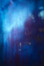 Old dirty dusty window glass with mystical reflection. Soft focus. Abstract background with scratches. Blue and magenta color