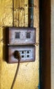 Old and dirty electric switches and plugs against gold background