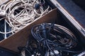 Old dirty electrical extension cords in a box