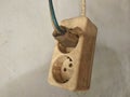 An old and dirty electrical plug and socket on wall