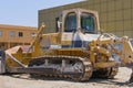 Old dirty extremely heavy bulldozer arrived to repair station. Yellow earthmover dozer machine.