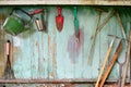 Old dirty farm gardening tools, spade, fork and rake on wooden wall Royalty Free Stock Photo