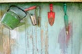 Old dirty farm gardening tools, spade, fork and rake on wooden wall Royalty Free Stock Photo