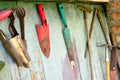 Old dirty farm gardening tools, spade, fork and rake on wooden wall Royalty Free Stock Photo