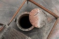 Old dirty fuel open hatch for cleaning from liquid chemical waste and oil of an abandoned tank industrial plant Royalty Free Stock Photo