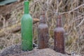 old dirty glass bottles stand on the gray ground Royalty Free Stock Photo