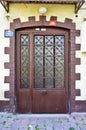 Old dirty iron door and door closer on brown cracked wall, Istanbul Buyukada Royalty Free Stock Photo