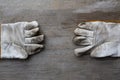 Old dirty leather work gloves on wood background, engineering equipment concept Royalty Free Stock Photo