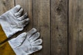 Old dirty leather work gloves on wood background Royalty Free Stock Photo