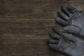 Old dirty leather work gloves on wood background Royalty Free Stock Photo