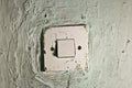 Old dirty light switch on old cracked wall Royalty Free Stock Photo