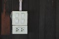 Old and Dirty Light Switches and Electrical Female Plugs on an Old Wooden Wall in an Old Wooden House