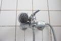 Old dirty limescale chalk covered shower head and bathtub faucet close up low angle view Royalty Free Stock Photo