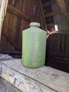 old and dirty pale green plastic bottle on wooden background