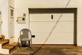 Old dirty plastic chair in front of the garage entrance, Pozo Izquierdo, Spain Royalty Free Stock Photo