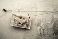 Old dirty rag hanging on a wire. Antique wall background