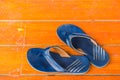 The Old, dirty rubber shoes on the orange floor. Top view and copy space Royalty Free Stock Photo