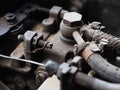 Old dirty rustic grunge middle size pick-up truck diesel power engine from 1970 crop closeup on worn out metal plastics and rubber