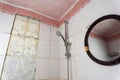 old dirty shabby bathroom with fallen tiles. old shelf. shower stand Royalty Free Stock Photo