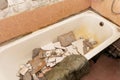 an old dirty shabby bathroom with fallen tiles. repair