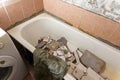 an old dirty shabby bathroom with fallen tiles. repair Royalty Free Stock Photo