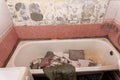 an old dirty shabby bathroom with fallen tiles. repair