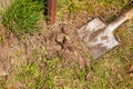 Old dirty shovel in the ground in the garden. Garden tools and equipment. The concept of gardening in summer or spring Royalty Free Stock Photo